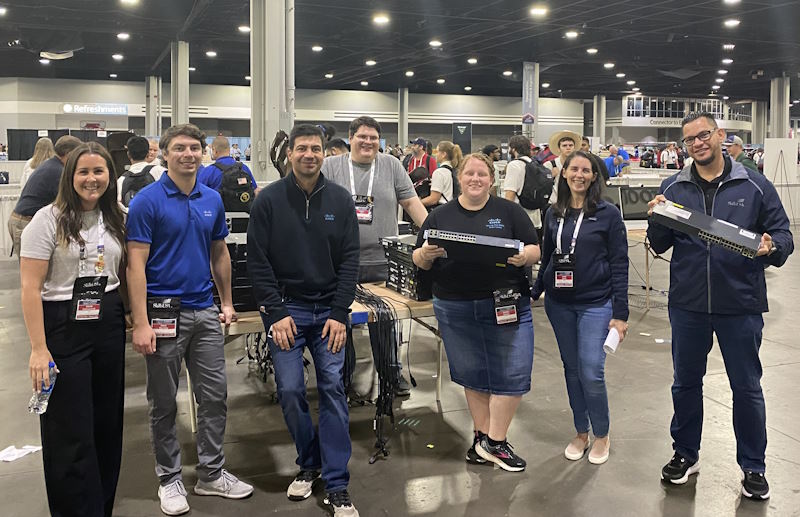 SkillsUSA’s Cisco team hold networking equipment.