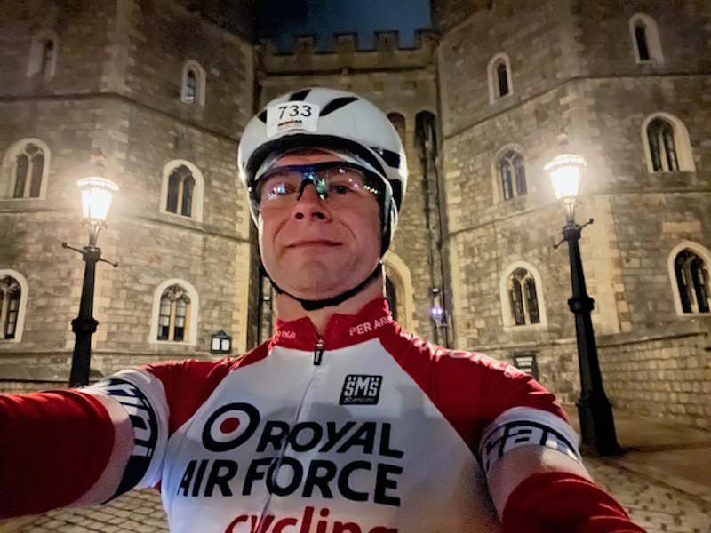 Mat wears Royal Air Force cycling kit outside a castle. 