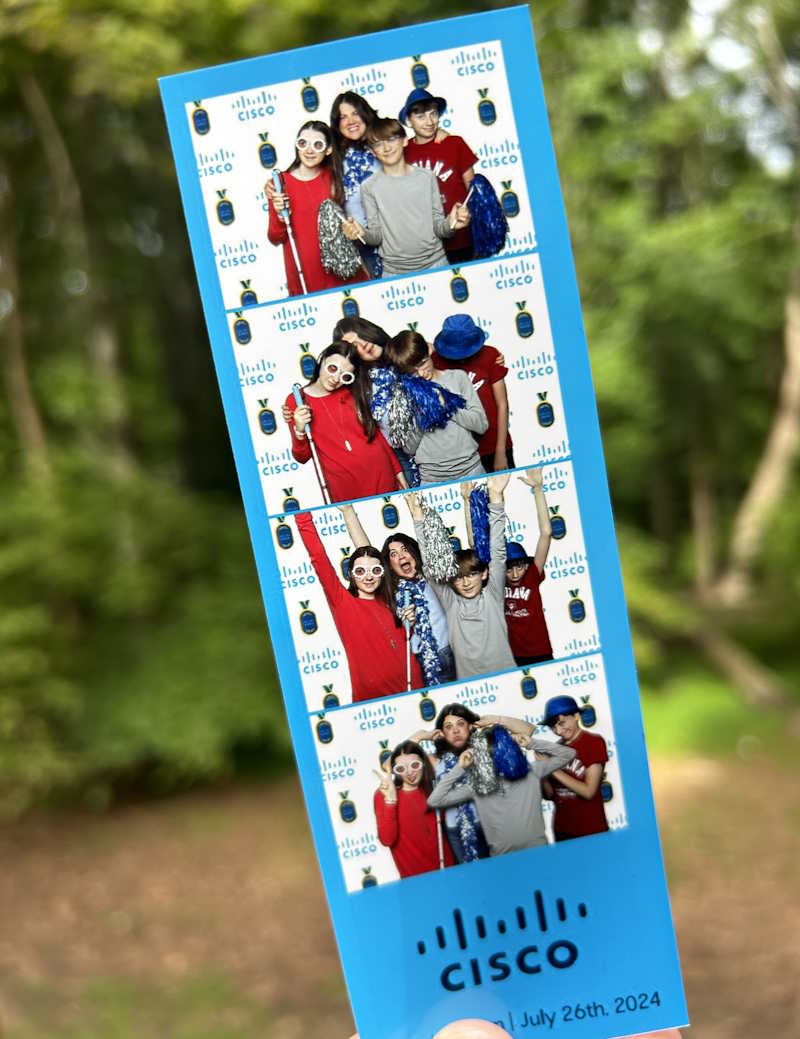 A photo booth film roll with smiling people dressed up in sunglasses and hats.