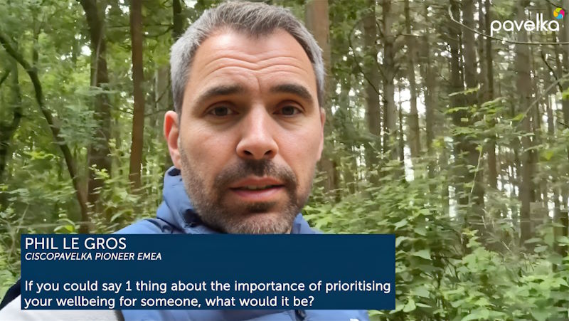 Phil stands in a forest, addressing Cisconians via a video message.