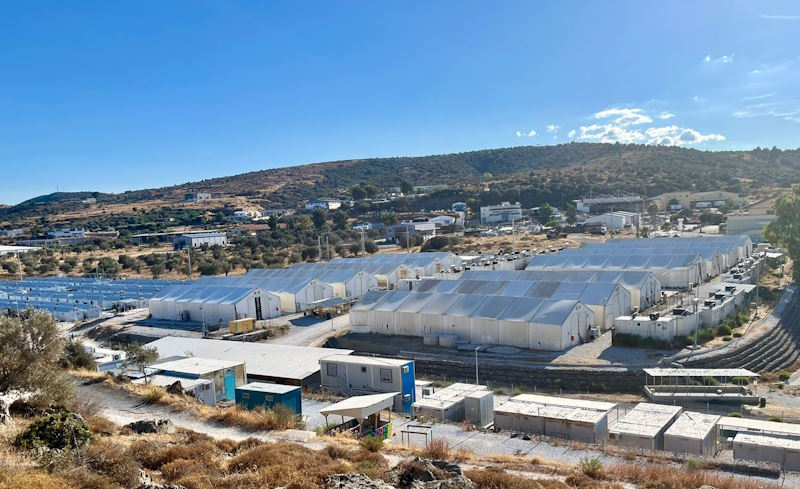 Several rows of containers and tents house the refugees. 