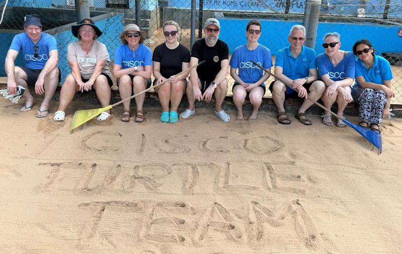 Nine people sit behind the words 