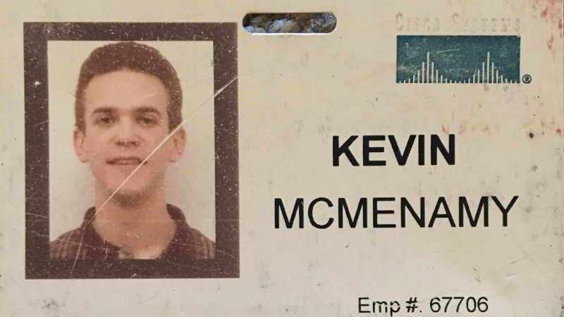 Kevin McMenamy’s original Cisco employee badge from 2000, featuring his employee photo and Cisco logo.