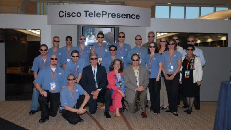Kevin and Cisco employees pose together at the Cisco TelePresence launch at GSX in 2006.